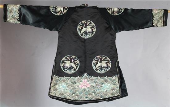 A Chinese black satin crane medallion jacket, early 20th century, replacements to sleeves